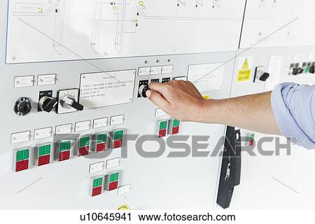 Worker adjusting gauge on panel View Large Photo Image Stock Image - Worker adjusting gauge on panel. Fotosearch