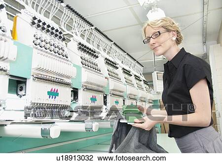 Worker examining fabric in factory View Large Photo Image Stock Image - Worker examining fabric in factory. Fotosearch