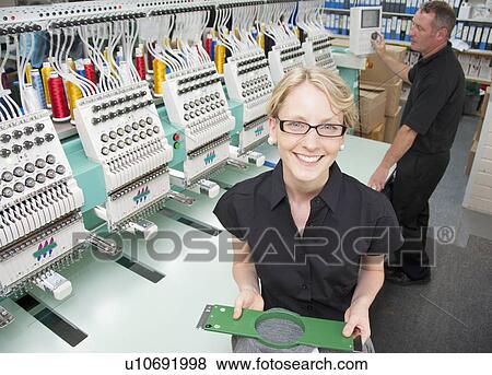 Worker examining fabric in factory View Large Photo Image Stock Photo - Worker examining fabric in factory. Fotosearch