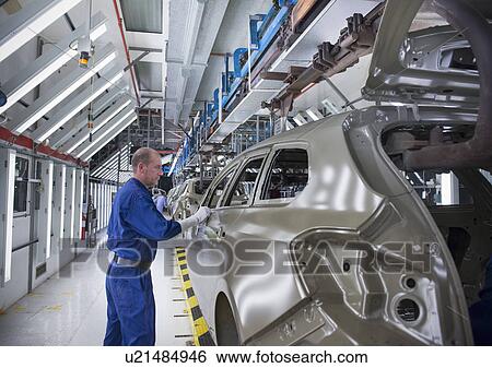 Worker inspecting car body in car factory View Large Photo Image Stock Photograph - Worker inspecting car body in car factory. Fotosearch