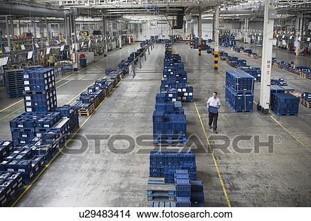 Picture - Worker selecting car parts in car factory. Fotosearch
