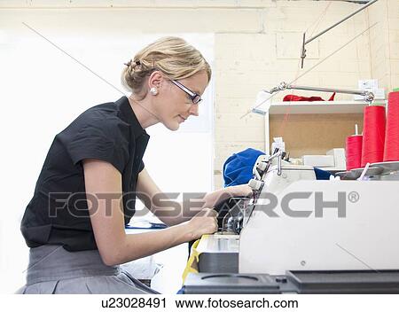 Worker sewing fabric in garment factory View Large Photo Image Stock Image - Worker sewing fabric in garment factory. Fotosearch