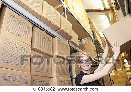 Worker stacking cardboard boxes View Large Photo Image Stock Image - Worker stacking cardboard boxes. Fotosearch