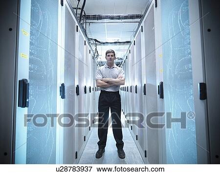 Stock Photo - Worker standing in server room. Fotosearch