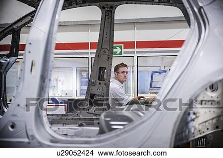 Worker with car body on measuring machine in car factory View Large Photo Image Picture - Worker with car body on measuring machine in car factory. Fotosearch