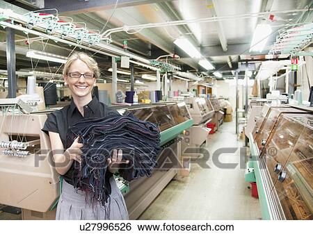 Stock Photograph - Worker with fabric in garment factory. Fotosearch