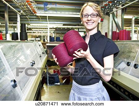 Worker with spools of thread in factory View Large Photo Image Stock Image - Worker with spools of thread in factory. Fotosearch
