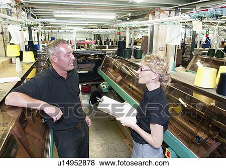 Workers talking in garment factory View Large Photo Image Stock Photo - Workers talking in garment factory. Fotosearch