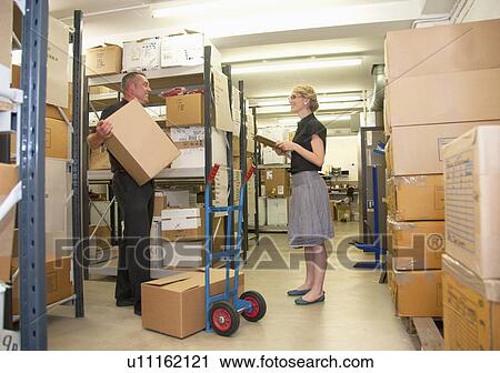 Workers talking in warehouse View Large Photo Image Stock Image - Workers talking in warehouse. Fotosearch