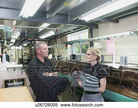 Stock Photography - Workers with fabric in garment factory. Fotosearch