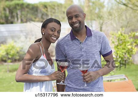 African American couple socializing around pool View Large Photo Image Stock Photograph - African American couple socializing around pool. Fotosearch