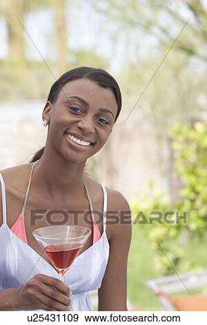 African American woman with drink at garden party View Large Photo Image Stock Photo - African American woman with drink at garden party. Fotosearch