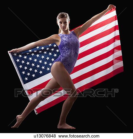Stock Photo - American gymnast in posing with American Flag. Fotosearch