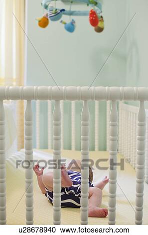 Baby girl (2-5 months) in crib View Large Photo Image Stock Image - Baby girl (2-5 months) in crib. Fotosearch