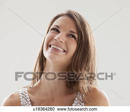 Beautiful woman smiling and looking up View Large Photo Image Stock Image - Beautiful woman smiling and looking up. Fotosearch