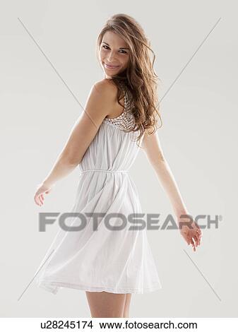 Beautiful woman swinging hips in summer dress View Large Photo Image Picture - Beautiful woman swinging hips in summer dress. Fotosearch