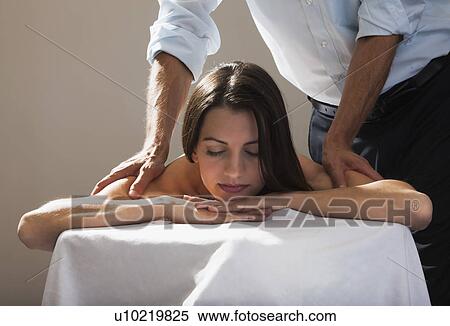 Stock Photography - Beautiful young woman getting a massage. Fotosearch