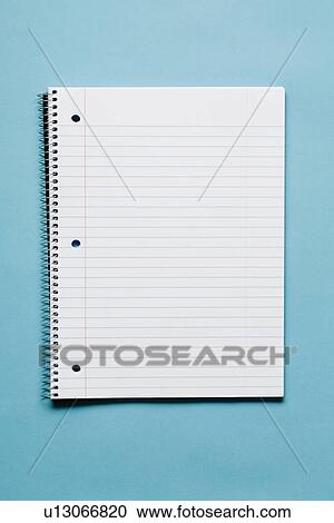 Stock Image - Blank spiral notebook on blue background. Fotosearch
