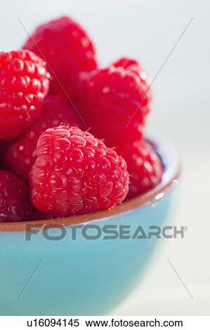 Stock Photography - Bowl filled with fresh raspberries. Fotosearch