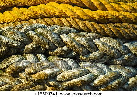 Stock Image - Braided ropes in harbor, close-up. Fotosearch