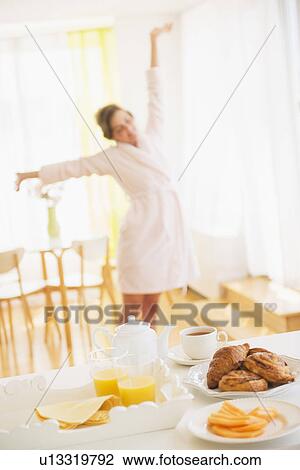 Breakfast scene with woman in white robe stretching View Large Photo Image Stock Image - Breakfast scene with woman in white robe stretching. Fotosearch