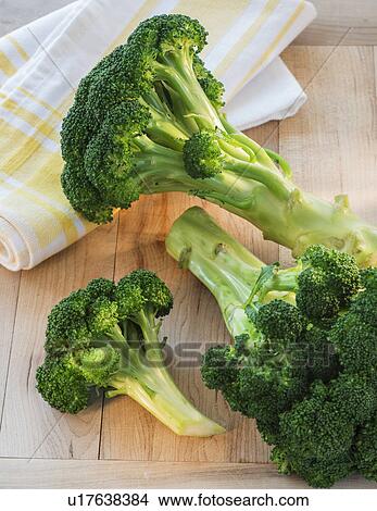 Picture - Broccoli on cutting board, studio shot. Fotosearch