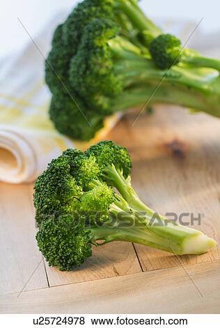 Stock Photo - Broccoli on cutting board, studio shot. Fotosearch