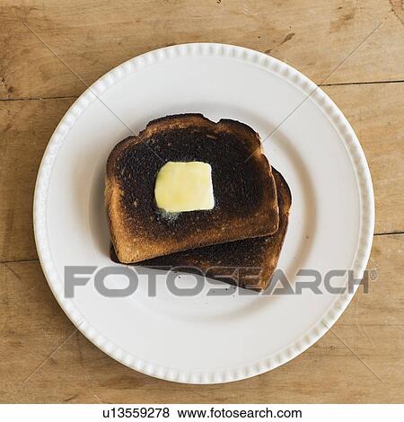 Stock Photo - Burnt toasts on plate. Fotosearch