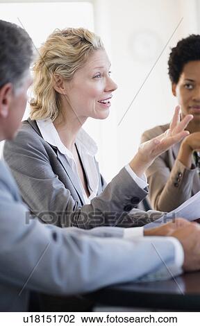 Stock Image - Business people at meeting. Fotosearch