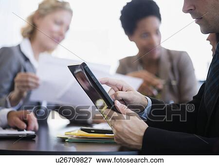 Stock Photo - Business people at meeting. Fotosearch