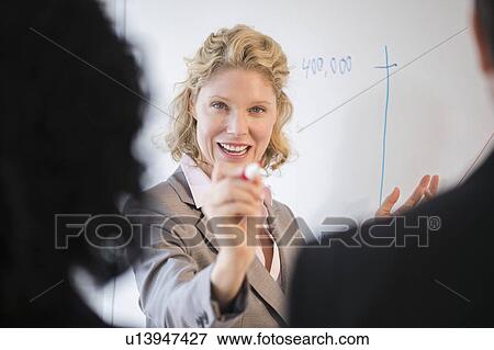 Stock Photo - Business woman during presentation. Fotosearch