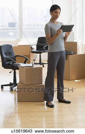 Businesswoman moving office View Large Photo Image Stock Image - Businesswoman moving office. Fotosearch