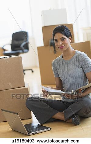 Businesswoman reading documents in new office View Large Photo Image Stock Image - Businesswoman reading documents in new office. Fotosearch