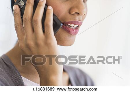 Stock Photo - Businesswoman talking on phone, studio shot. Fotosearch
