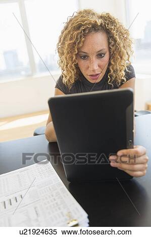 Businesswoman using digital tablet in office View Large Photo Image Stock Photography - Businesswoman using digital tablet in office. Fotosearch