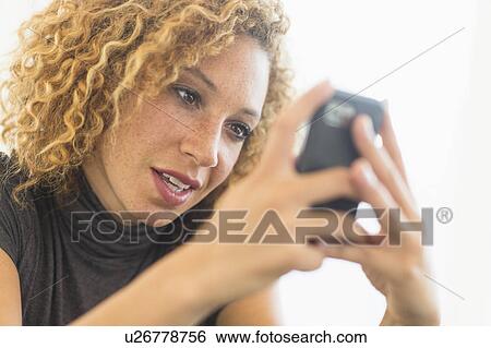Businesswoman using smart phone View Large Photo Image Stock Photograph - Businesswoman using smart phone. Fotosearch