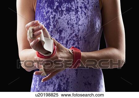 Close-up of gymnast adjusting grips on hands View Large Photo Image Stock Photography - Close-up of gymnast adjusting grips on hands. Fotosearch