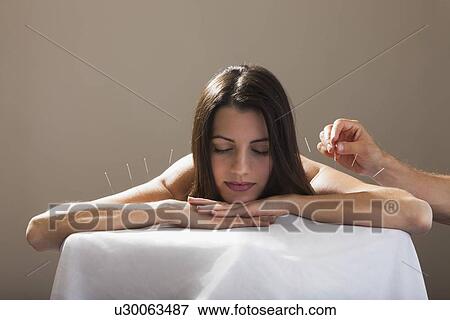 Close-up of woman with acupuncture needles in her arm and shoulders View Large Photo Image Stock Photo - Close-up of woman with acupuncture needles in her arm and shoulders. Fotosearch