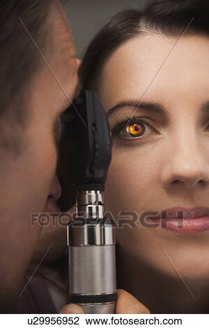 Close up of woman's eye lit up from doctor doing eye test View Large Photo Image Stock Image - Close up of woman's eye lit up from doctor doing eye test. Fotosearch