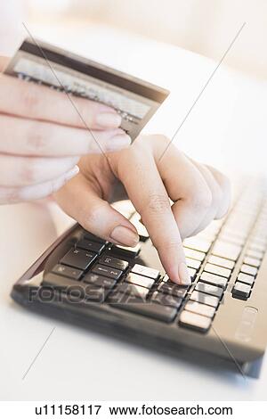 Close up of woman's hand doing online banking with laptop View Large Photo Image Stock Photo - Close up of woman's hand doing online banking with laptop. Fotosearch
