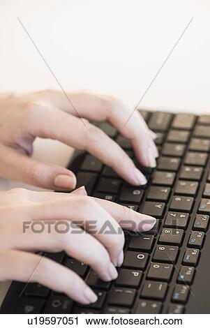 Close up of woman's hands typing on computer keyboard View Large Photo Image Stock Image - Close up of woman's hands typing on computer keyboard . Fotosearch