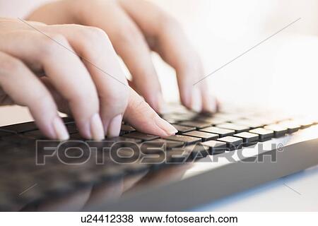 Close up of woman's hands typing on computer keyboard View Large Photo Image Stock Photo - Close up of woman's hands typing on computer keyboard . Fotosearch