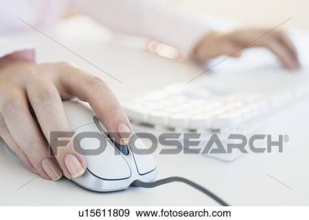 Close up of woman's hands using computer keyboard and computer mouse View Large Photo Image Stock Photo - Close up of woman's hands using computer keyboard and computer mouse. Fotosearch