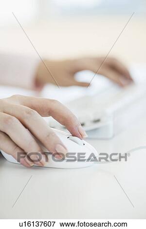 Close up of woman's hands using computer keyboard and computer mouse View Large Photo Image Stock Photo - Close up of woman's hands using computer keyboard and computer mouse. Fotosearch