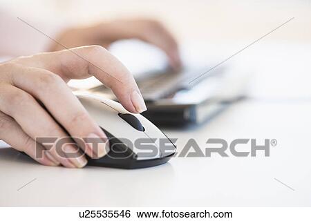 Close up of woman's hands using computer keyboard and computer mouse View Large Photo Image Stock Photograph - Close up of woman's hands using computer keyboard and computer mouse. Fotosearch