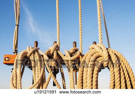 Stock Image - Coiled ropes on yacht deck. Fotosearch