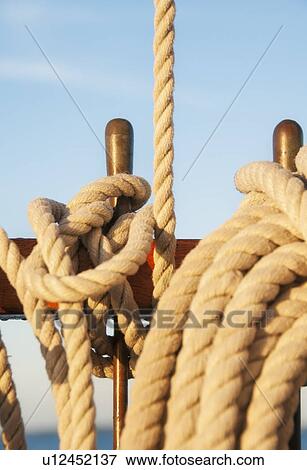 Stock Photo - Coiled ropes on yacht deck. Fotosearch