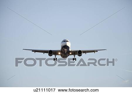 Commercial jet airliner flying towards camera View Large Photo Image Stock Photo - Commercial jet airliner flying towards camera. Fotosearch