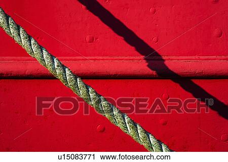 Stock Image - Detail of red tugboat with rope. Fotosearch