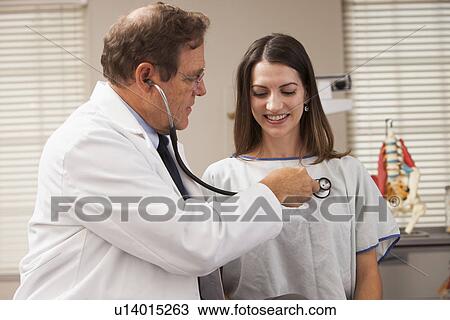 Doctor checking patients heart rate with Stethoscope View Large Photo Image Stock Image - Doctor checking patients heart rate with Stethoscope. Fotosearch